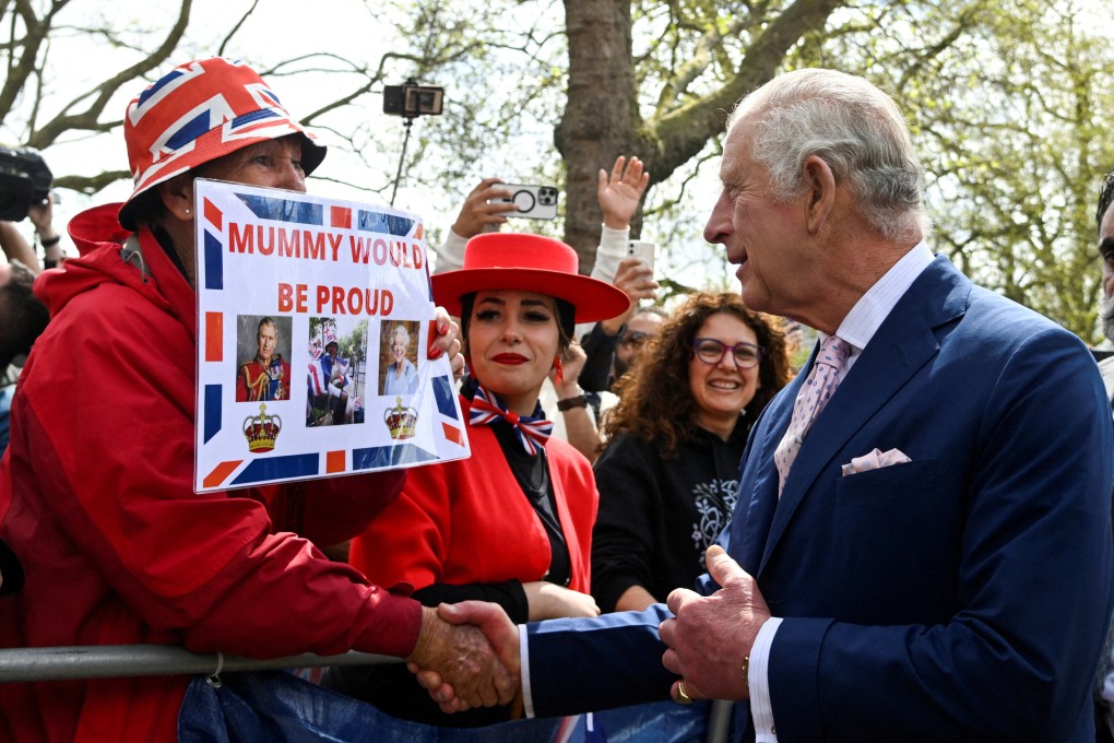 Britain’s King Charles shakes hands with supporters outside Buckingham Palace on Friday, ahead of his coronation. Photo: Reuters