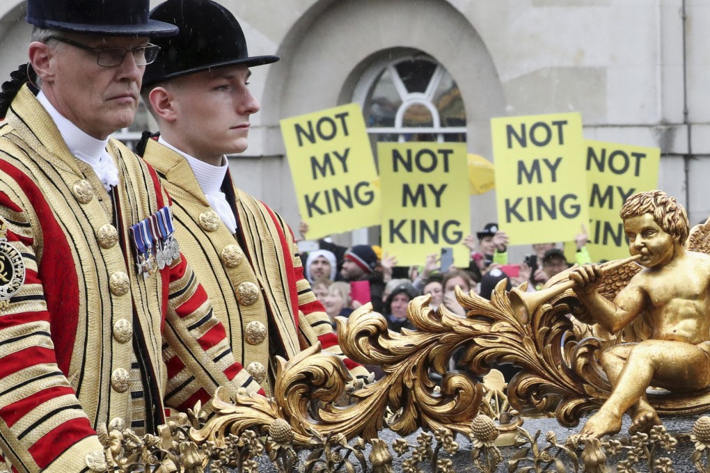 A coach carrying Britain’s Prince William, Kate, Princess of Wales, and their children rides past protesters following the coronation ceremony of King Charles III on Saturday. Photo: via AP