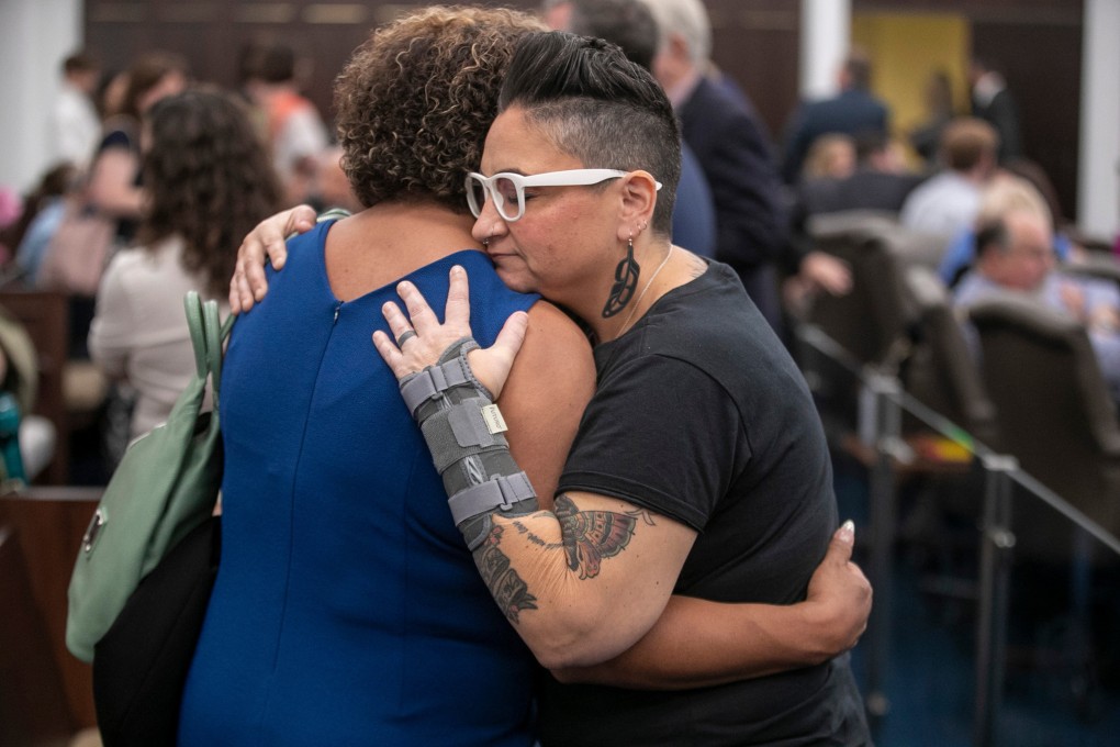 Members of the LGBT community in North Carolina, US, embrace on May 2 after they were not allowed to speak at a public hearing about legislation that would ban gender-affirming care for minors. Photo: TNS