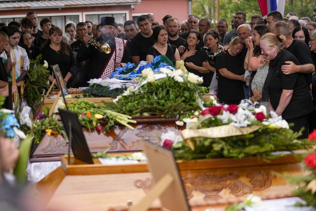 Mourners attend a funeral for five people killed during the second mass shooting in two days, in the village of Malo Orasje, south of Belgrade, Serbia on Saturday. Photo: AP