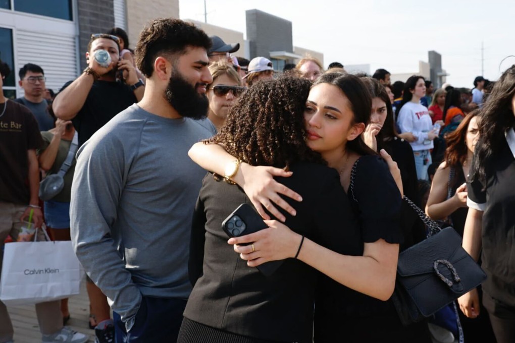 People embrace outside the Allen Premium Outlets, where authorities responded to reports of an active shooter on Saturday, May 6, 2023, in Allen, Texas. Photo: TNS