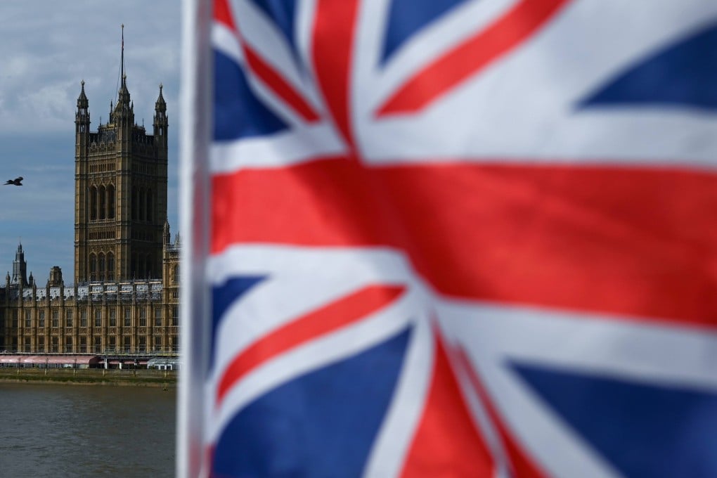The Palace of Westminster, housing the British houses of Parliament, is seen from Westminster Bridge with a Union flag in the foreground, in central London on August 28, 2019. Photo: AFP