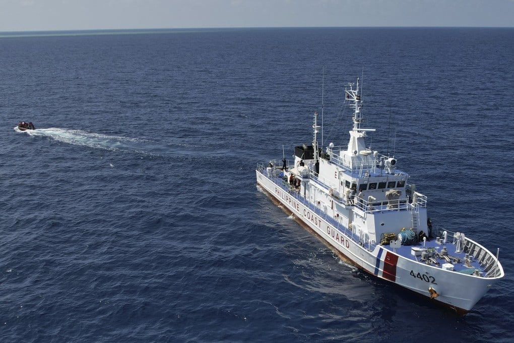 A Philippine Coast Guard vessel deploys a boat to transport supplies at Philippine-occupied Nanshan Island or locally called Lawak in the South China Sea. Photo: AP