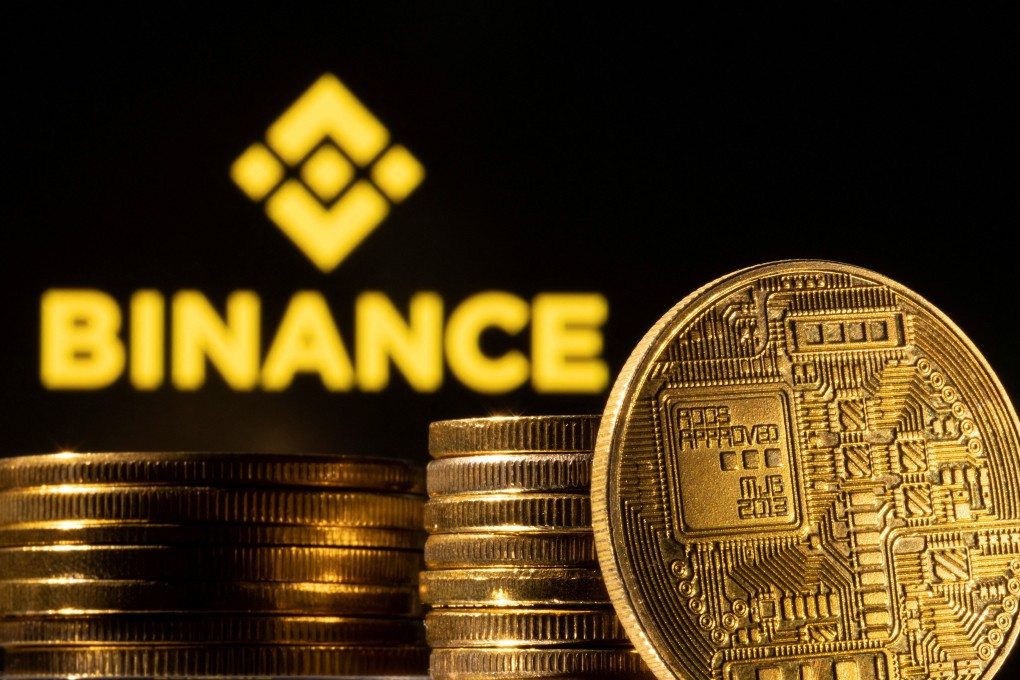 A representation of the cryptocurrency is seen in front of Binance logo. Photo: Reuters
