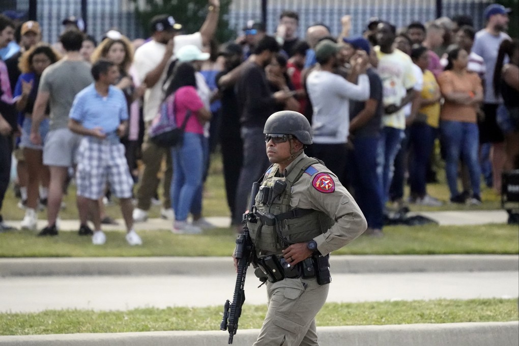 A law enforcement officer at the scene as people are evacuated from a shopping centre where a shooting occurred Saturday, in Allen, Texas. Photo: AP