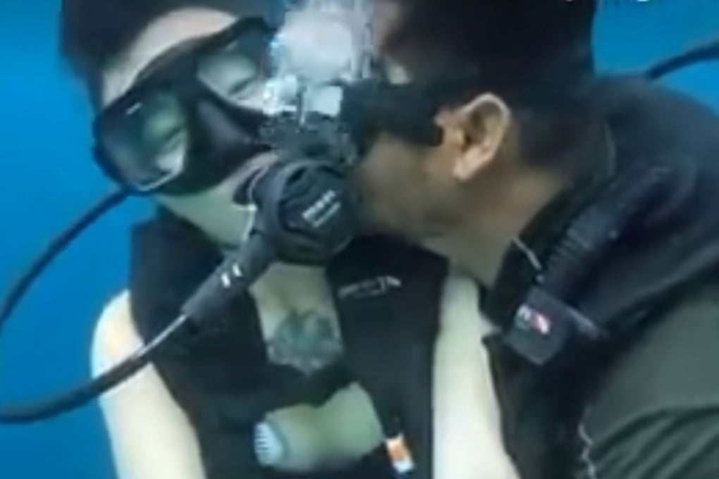 The Malaysian diving instructor is seen kissing the Chinese tourist while they were diving in waters off Semporna in this screengrab from a video. Photo: Facebook/SempornaInfo