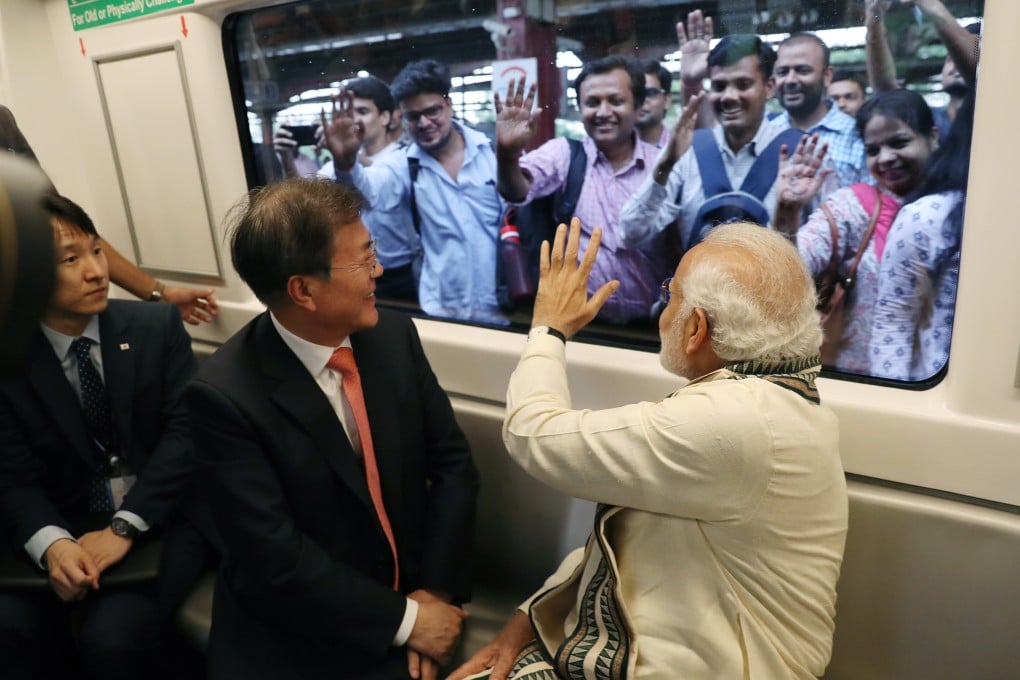 South Korea’s then president Moon Jae-in and Indian Prime Minister Narendra Modi greet onlookers during their subway ride to the Samsung Electronics factory in Uttar Pradesh, northern India, on July 9, 2018. South Korean firms are increasingly looking to India as a target for investment and expansion. Photo: EPA-EFE