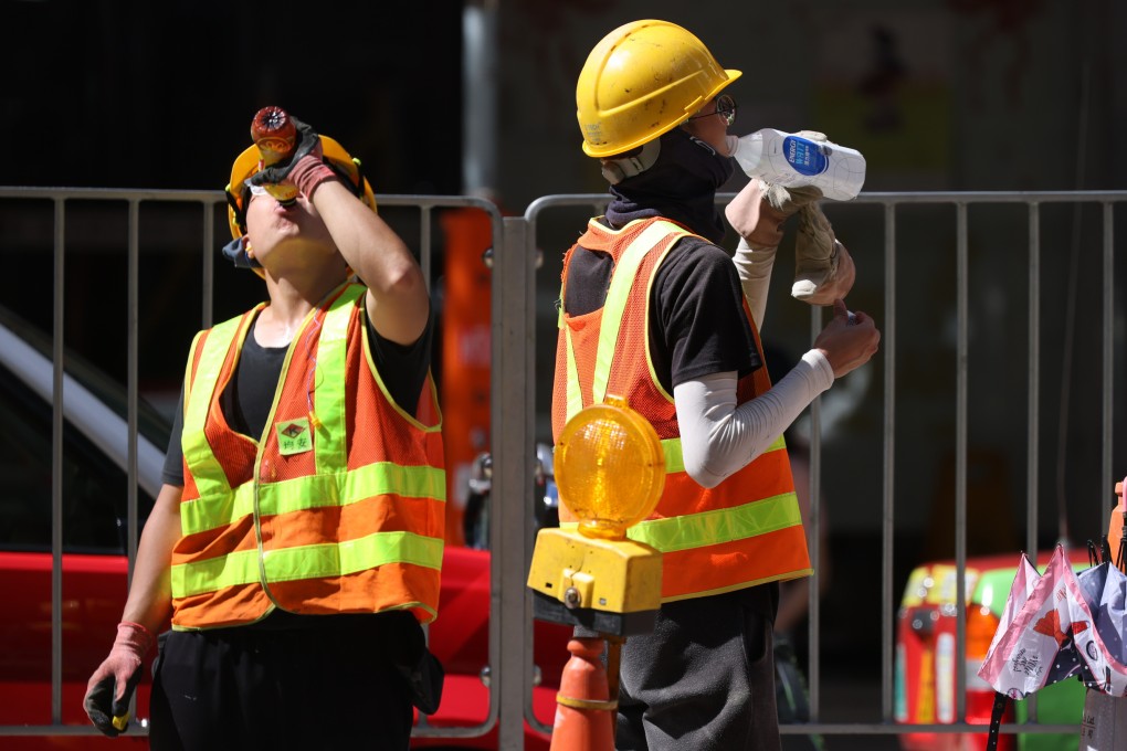 Road workers battle the heat in Wan Chai. Photo: Nora Tam