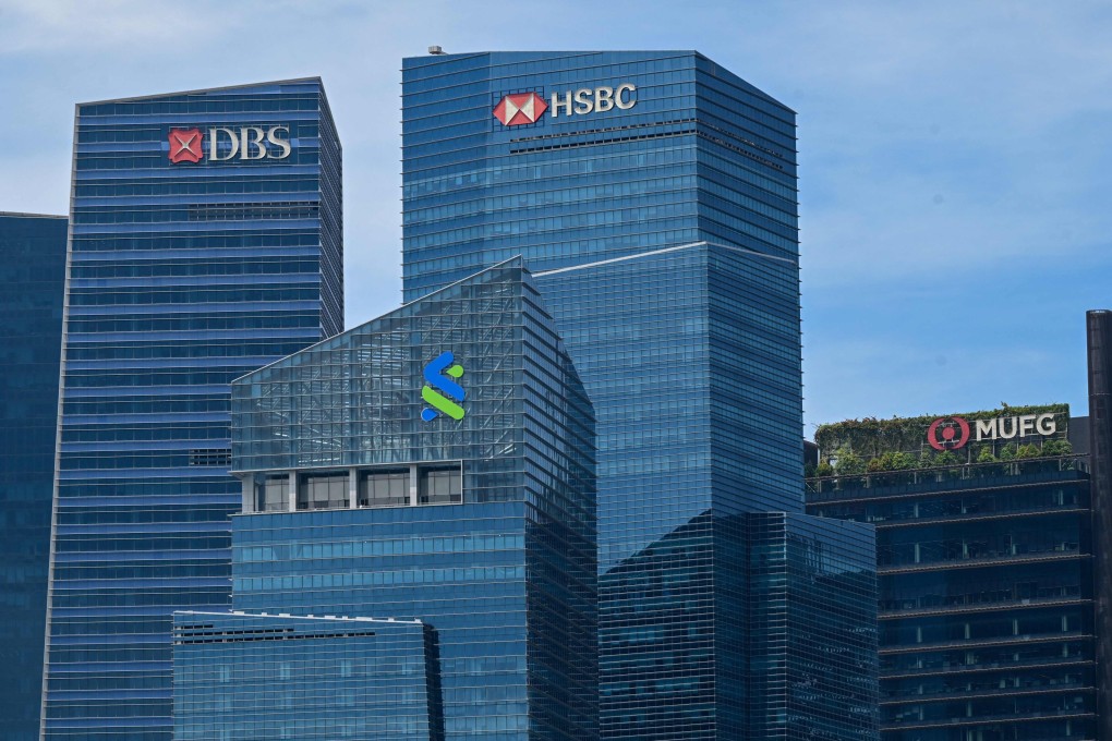 Bank headquarters are seen in Singapore’s Marina Bay Financial Centre district. DBS Group Holdings Ltd., Standard Chartered Plc and HSBC Holdings Plc will be among the first banks in the city state to access Cosmic. Photo: AFP