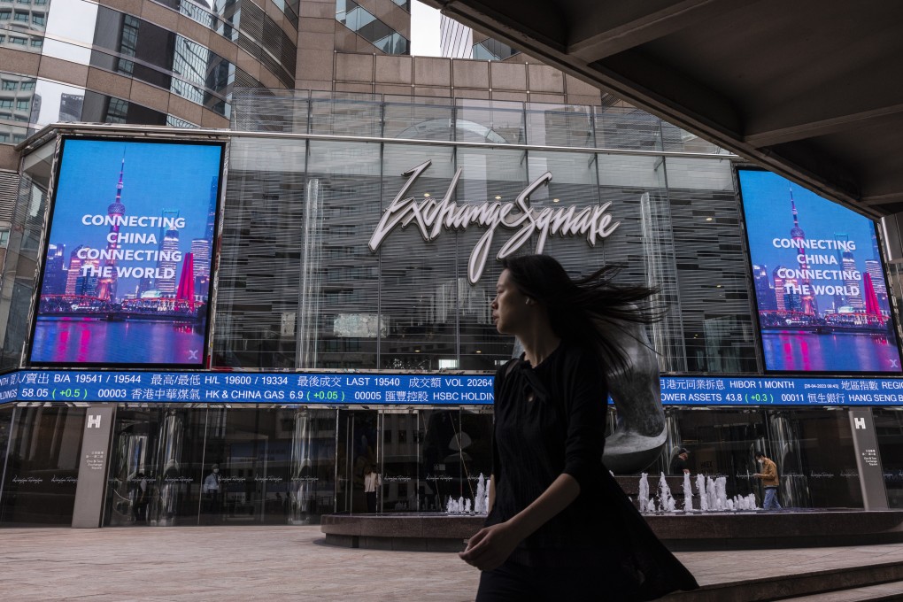 A pedestrian passes by the Hong Kong stock exchange electronic screen. Photo: AP Photo