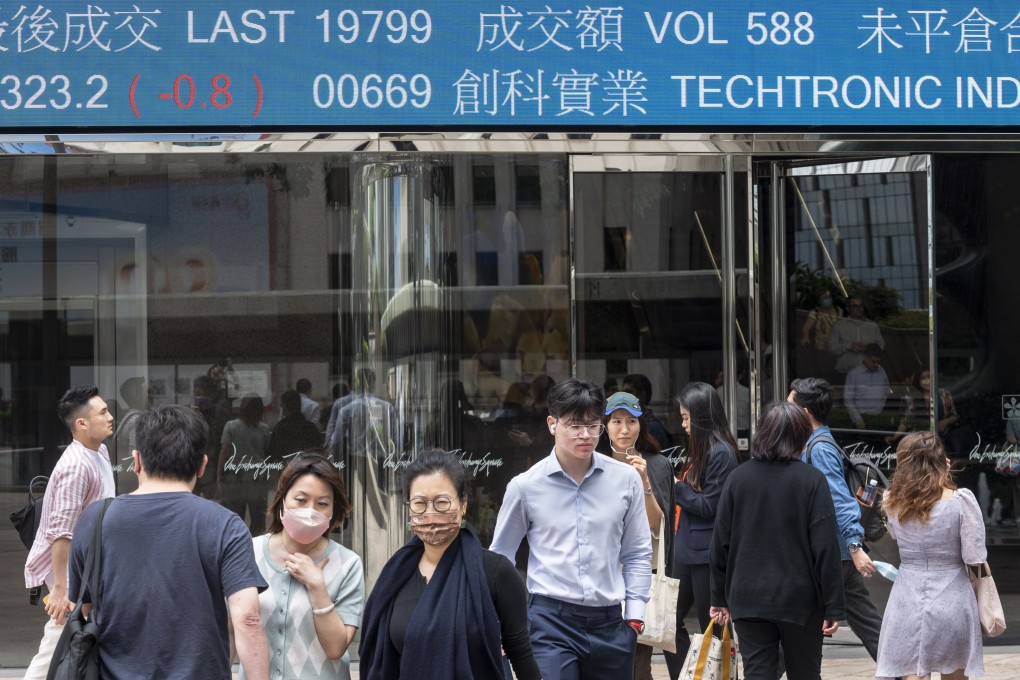 Pedestrians walk past a stock ticker outside Exchange Square, the building housing the Hong Kong stock exchange. Photo: EPA-EFE