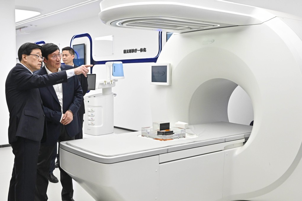 John Lee (left) visits Jinfeng Laboratory in Chongqing on Thursday. Photo: Handout