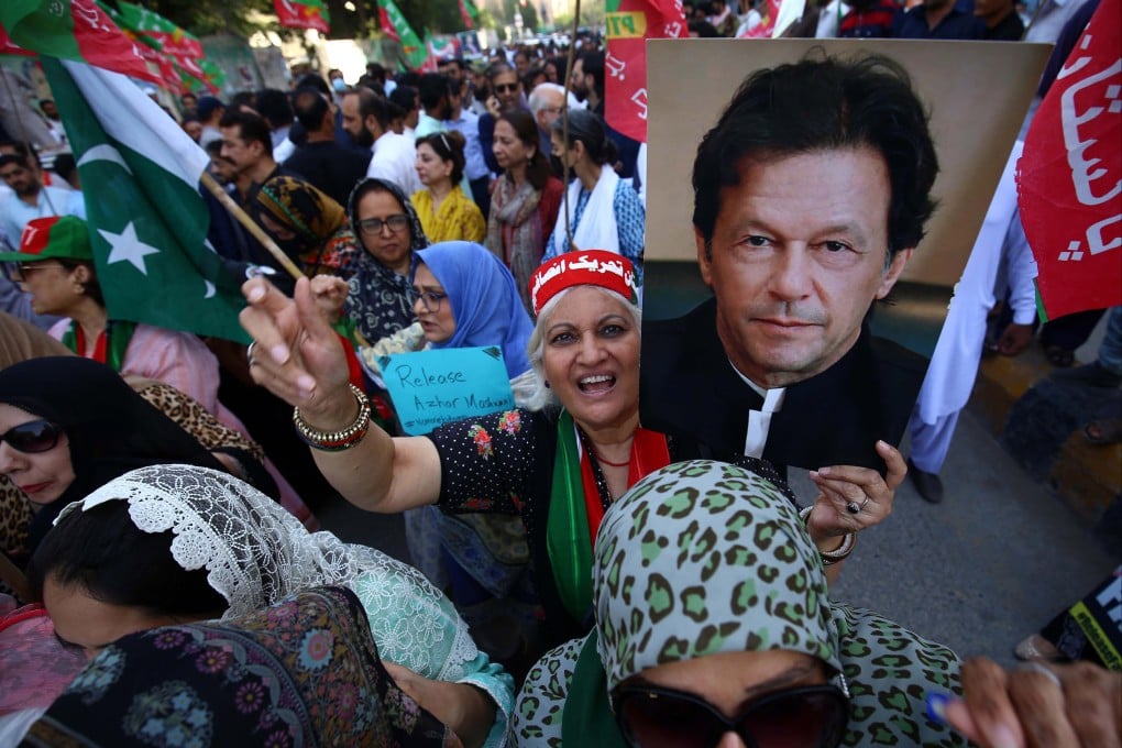 A supporter holds a poster of Imran Khan during a protest. Photo: EPA-EFE