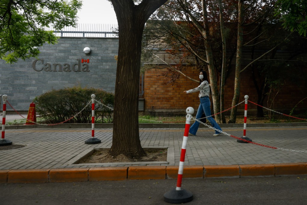 A woman walks by the Canadian embassy in Beijing on May 9. Canada and China have each expelled a diplomat from the other side. Photo: EPA-EFE