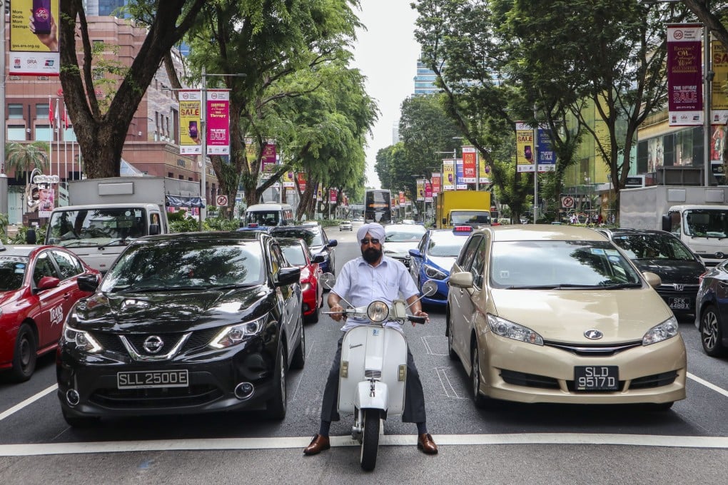 Motorists wait at a junction on Orchard Road in Singapore. Certificates of entitlement were introduced in 1990 to limit the number of vehicles on the road. Photo: Roy Issa