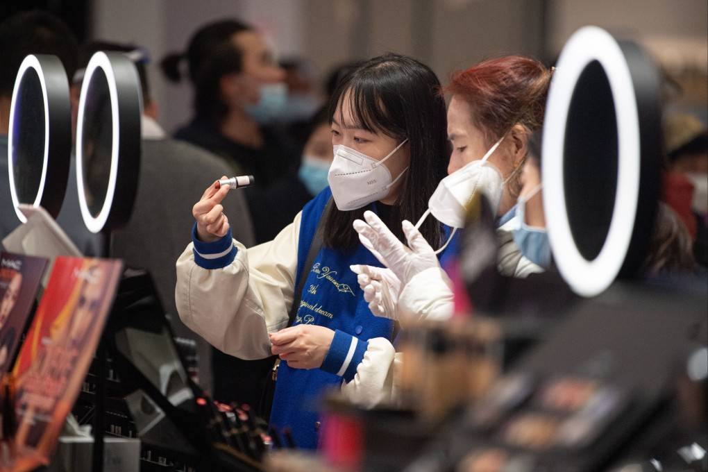 Customers select cosmetics at a duty-free shop in Hainan. Photo: Xinhua