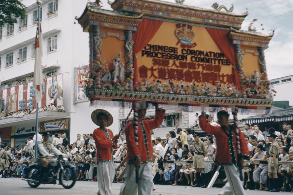 A procession in Hong Kong to celebrate the coronation of Queen Elizabeth in June 1953. The Chinese Coronation Procession Committee march by with a large sign. Photo: Getty Images
