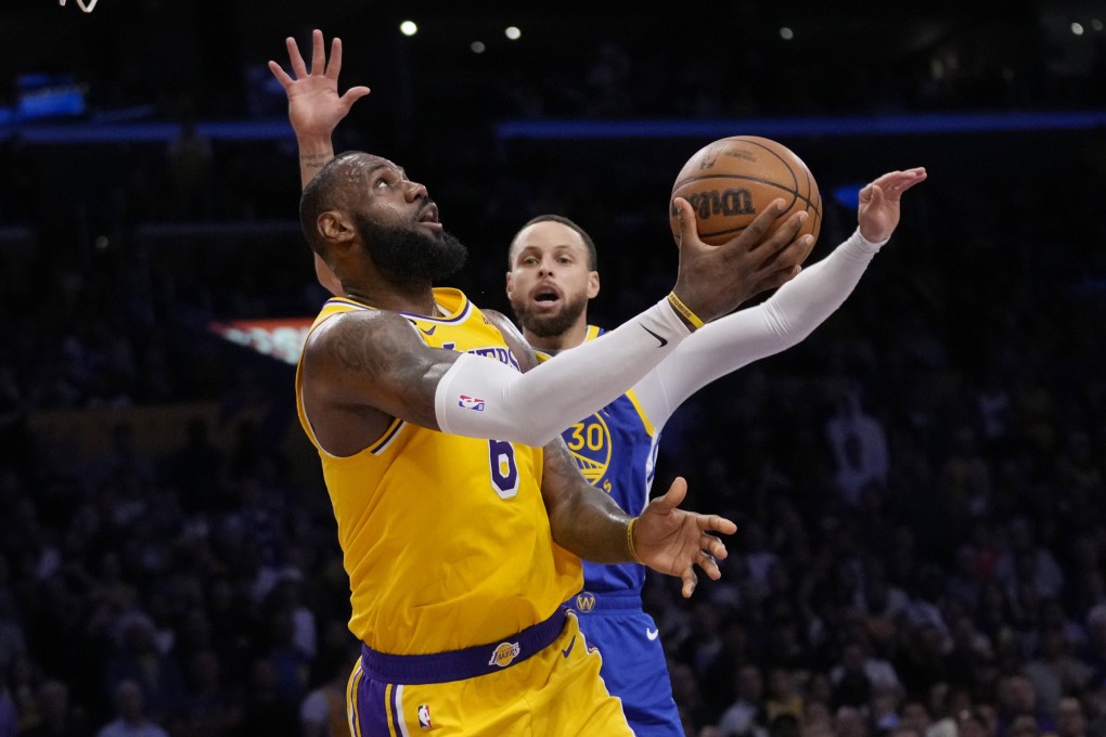 Los Angeles Lakers forward LeBron James scores past Golden State Warriors guard Stephen Curry during the second half in Game 6. Photo: AP