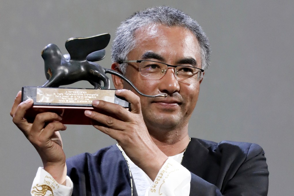 Pema Tseden with the trophy for best screenplay at the 2018 Venice Film Festival. Photo: Getty Images