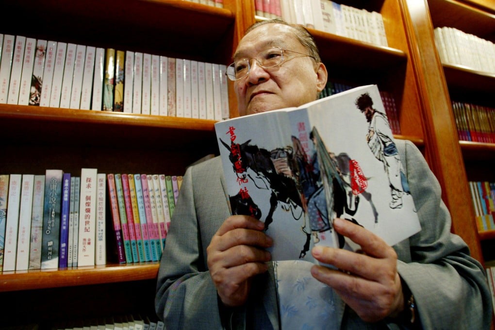Hong Kong wuxia author Louis Cha Leung-yung, known by his pen name Jin Yong, holds a copy of his novel “Book and Sword, Gratitude and Revenge” at his office in the city on July 29, 2002. Photo: Reuters
