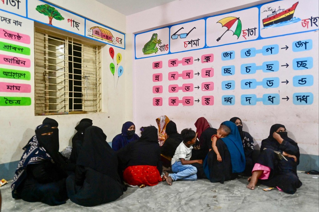 Women take shelter with their children in Shahpori island on the outskirts of Teknaf, Bangladesh on Saturday ahead of Cyclone Mocha’s landfall. Photo: AFP