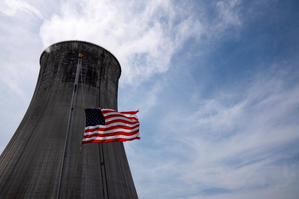 The US flag flies at half mast in front of a coal-fired power plant’s cooling tower at Duke Energy’s Crystal River Energy Complex in Florida. Photo: Reuters