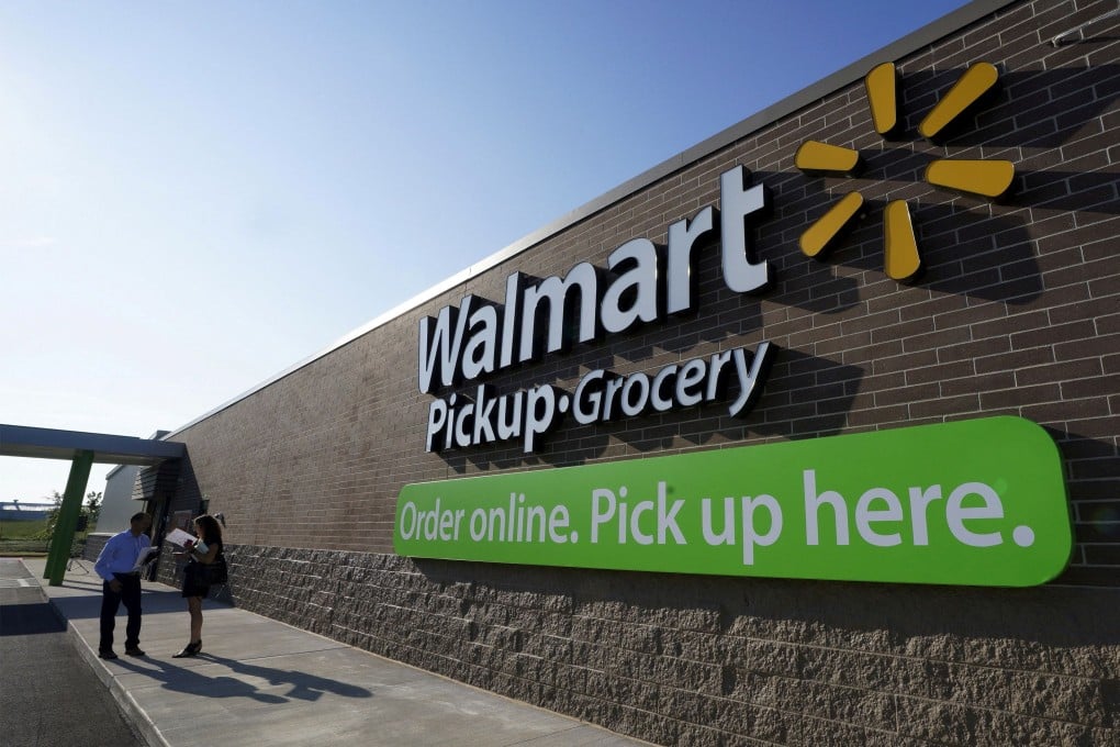 People talk outside a Walmart store in Bentonville, Arkansas, on May 5. The retail giant sells more than half of all groceries in some areas of the US. Photo: Reuters