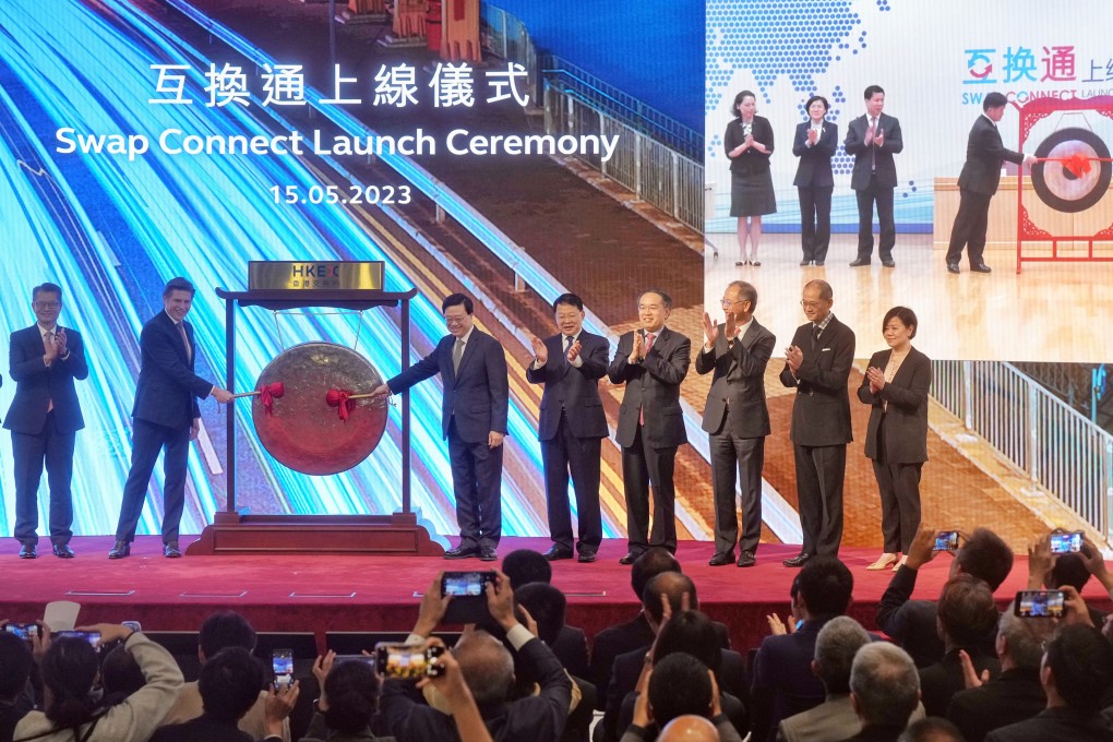 Left to right: Paul Chan Mo-po, Financial Secretary; Nicolas Aguzin, CEO of HKEX; John LEE Ka-chiu, Chief Executive of the Hong Kong SAR; Yin Zonghua; Christopher Hui, Secretary for Financial Services and the Treasury; Eddie Yue Wai-man, CEO of Hong Kong Monetary Authority; Hugo Leung, independent non-executive director of HKEX; and Glenda So, co-head of markets at HKEX mark the launch of the northbound Swap Connect on May 15, 2023 in Hong Kong. Photo: Elson Li