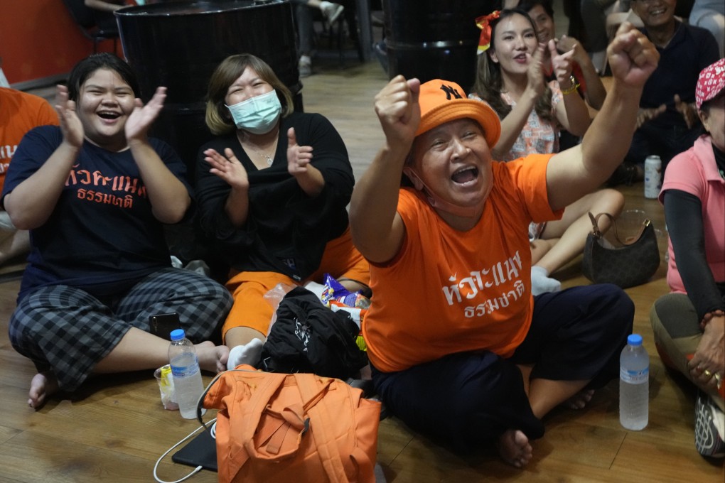 Supporters of the Move Forward Party cheer as they watch the counting of votes on television after Sunday’s election. Photo: AP