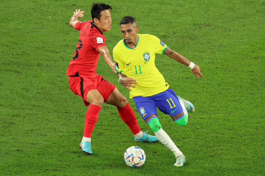 South Korea’s Son Jun-ho attempts to stop Brazil’s Raphinha during their World Cup clash in Qatar last December. Photo: Reuters