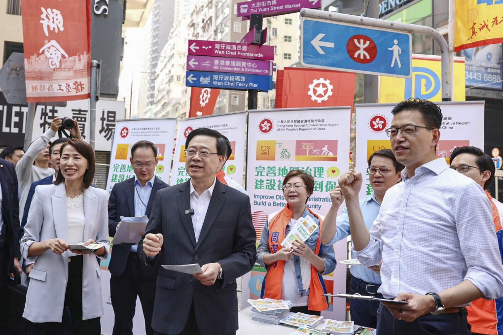 Chief Executive John Lee visits a booth promoting district council reform in Wan Chai on May 5. Photo: Handout