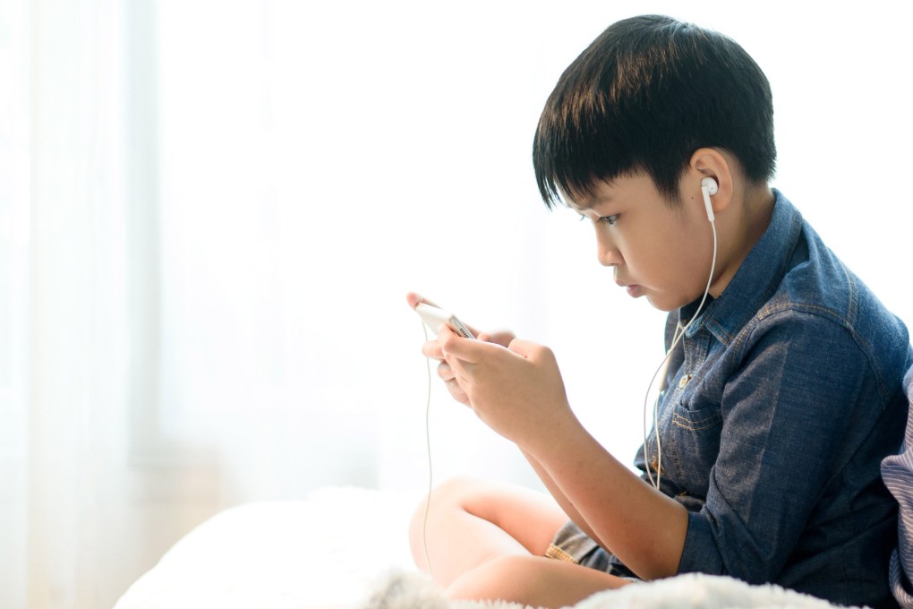 A young boy uses a mobile phone. The woman’s son in the case (not pictured) was hospitalised for several weeks following the attack. Photo: Shutterstock