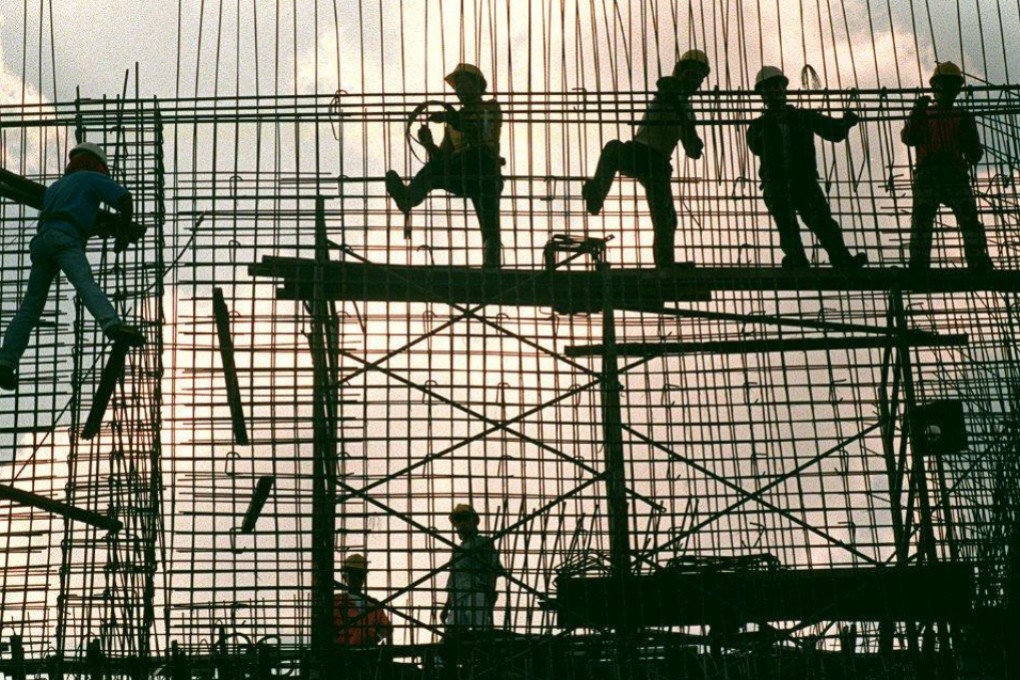 Workers erect a reinforcement grid of iron bars for a concrete wall of a power substation in Manila. Photo: AFP