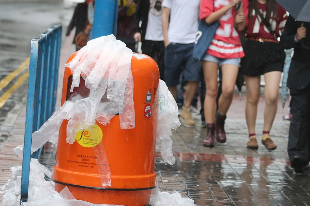 A bin overflows with plastic umbrella bags on a rainy day in Kwun Tong. Two-thirds of plastic is produced for single use. Photo: David Wong