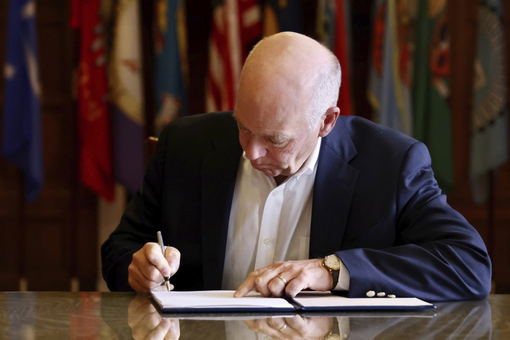 Greg Gianforte, the state’s Republican governor, signs the measure into law in Helena, Montana, on Wednesday. Photo: Montana Governor’s Office via AP
