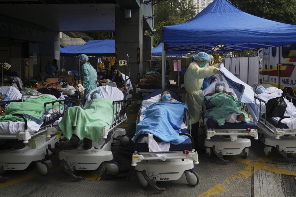 Patients lie on hospital beds as they wait at a temporary makeshift treatment area outside the Caritas Medical Centre during Hong Kong’s Covid-19 fifth wave in February 2022. Photo: AP