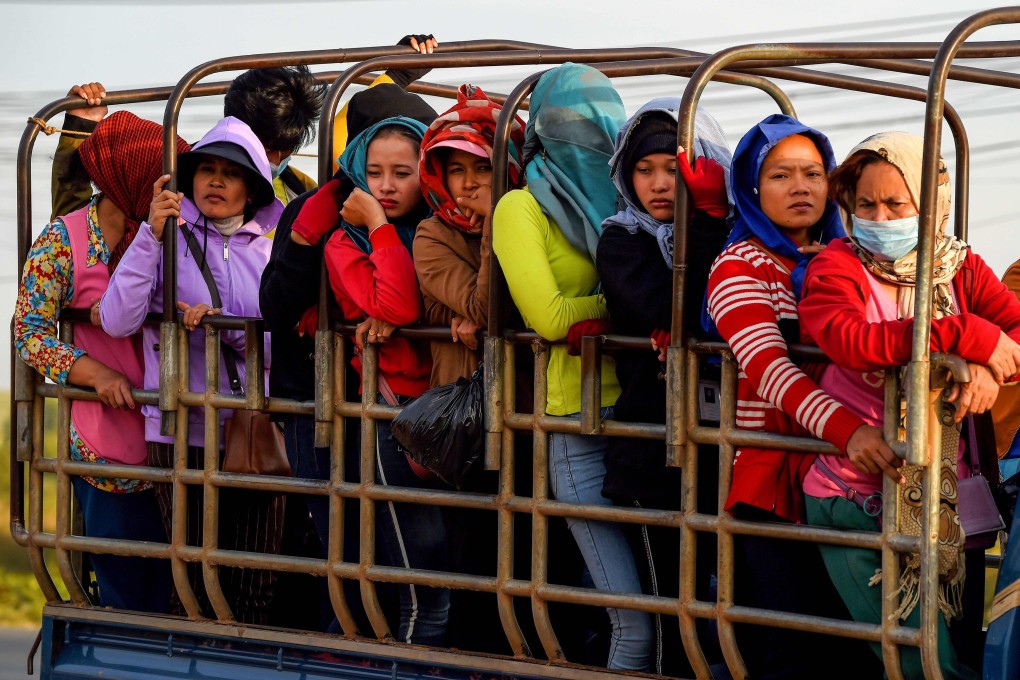 Garment factory workers stand in a truck, which they use to commute to and from work, in Kampong Speu province, Cambodia, in December 2019. Photo: AFP