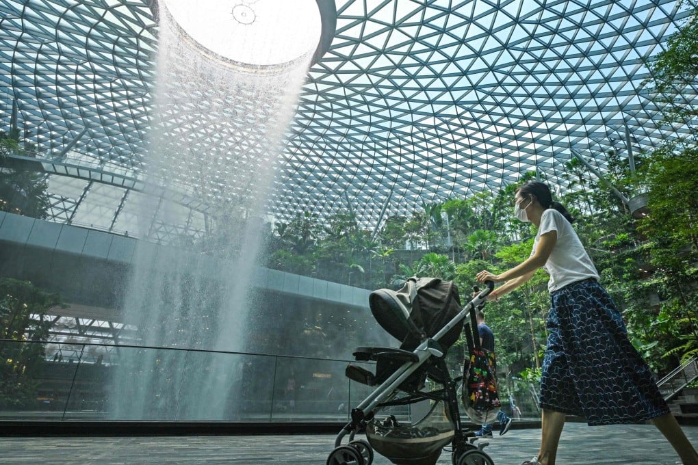 A woman pushes a pram at Jewel Changi Airport. Photo: AFP