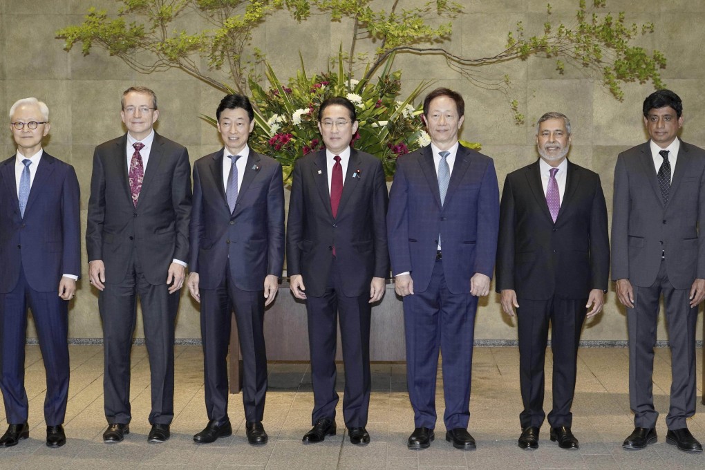 Japanese Prime Minister Fumio Kishida, centre, and Economy Minister Yasutoshi Nishimura, centre-right, pose with the heads of global chip companies. From left to right, Kyung Kye Hyun of Samsung, Patrick Gelsinger of Intel, Mark Liu of TSMC, Sanjay Mehrotra of Micron, and Prabu Raja of Applied Materials, on Thursday in Tokyo. Photo: Kyodo News via AP