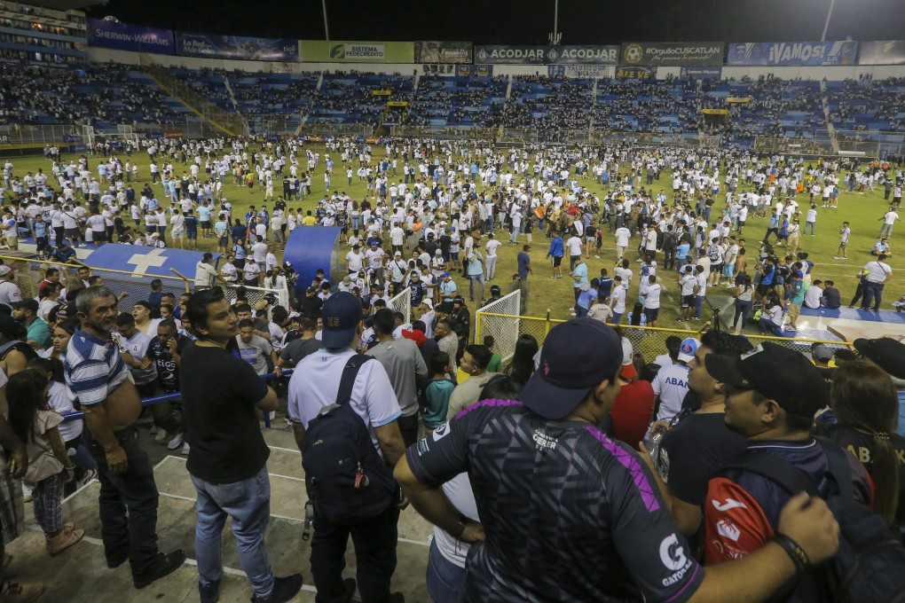 Fans spill on to the field at Cuscatlan Stadium in San Salvador after a crush that left at least 12 people dead. Photo: AP
