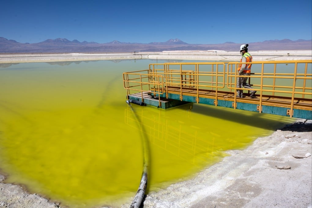 A lithium mine supervisor inspects an evaporation pond of lithium-rich brine in the Atacama Desert in Salar de Atacama, Chile. Photo: Getty Images