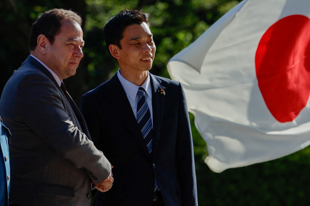 Ukraine’s ambassador to Japan Sergiy Korsunsky and Japan’s State Minister of Defence Toshiro Ino attend a handover ceremony of Japanese Self-Defence Force’s vehicles to Ukraine. Photo: Reuters