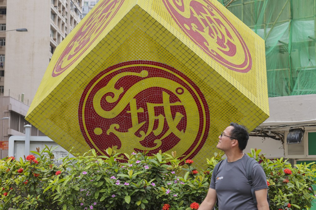 A man walks past the Kowloon City District Council logo on May 2. It is important for district councillors to be well versed in the economy of their district. Photo: Jelly Tse