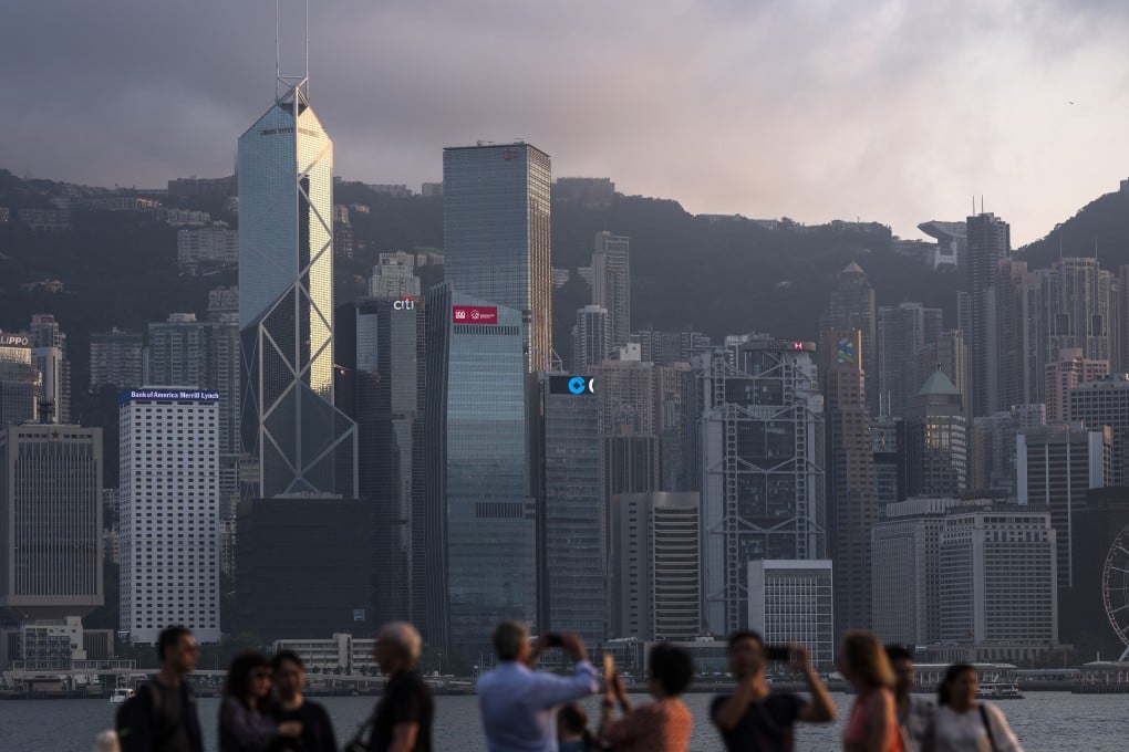 People take photos of the Hong Kong skyline featuring major banks from the Tsim Sha Tsui waterfront on April 29, 2019. Photo: Bloomberg