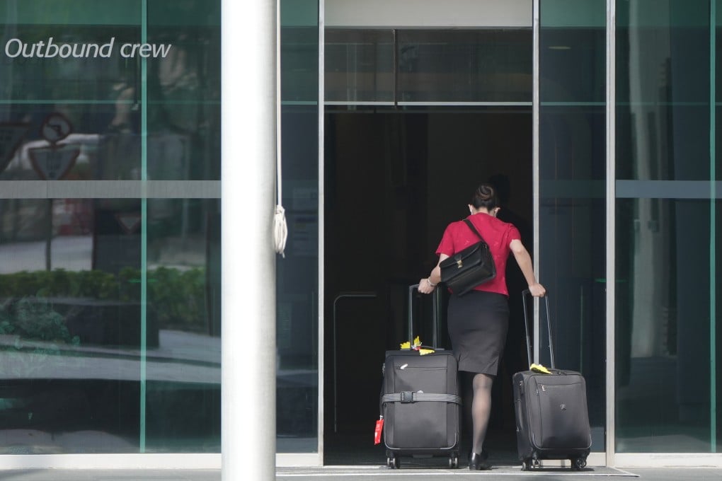 An employee heads into Cathay City, the airline’s headquarters near Hong Kong airport. Photo: Sam Tsang