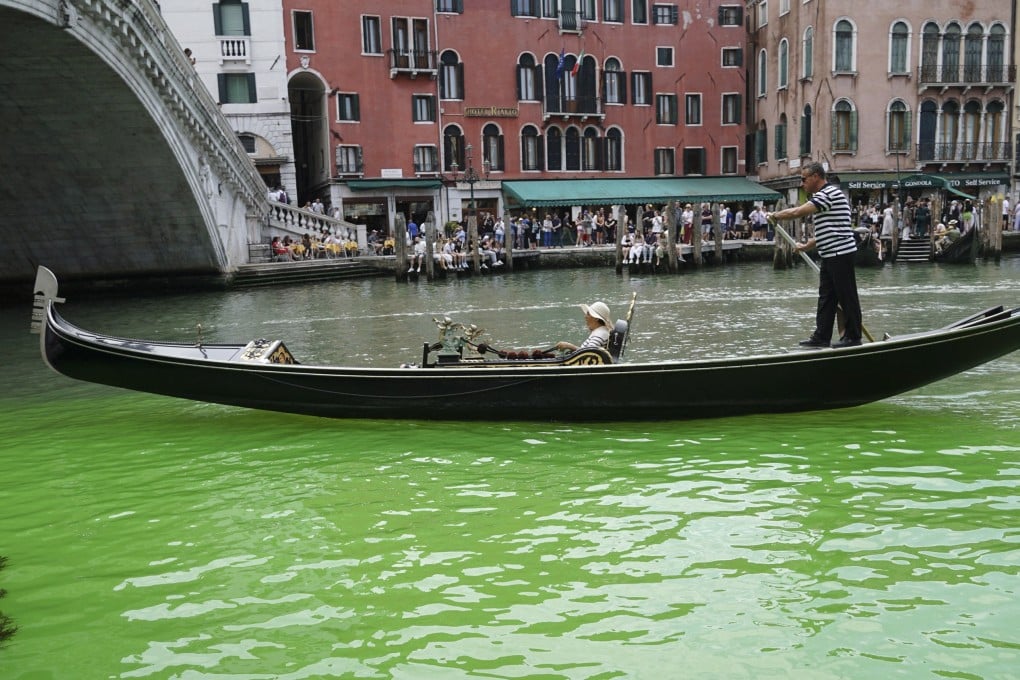 A gondola moves along a patch of phosphorescent green water in Venice, Italy, on Sunday. Photo: EPA-EFE