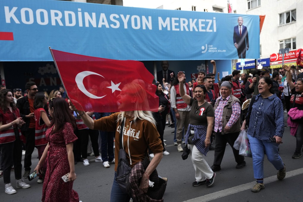 A supporter of Nation Alliance’s presidential candidate Kemal Kilicdaroglu walks with a national flag after an election campaign rally in Ankara, Turkey on Saturday. Photo: AP