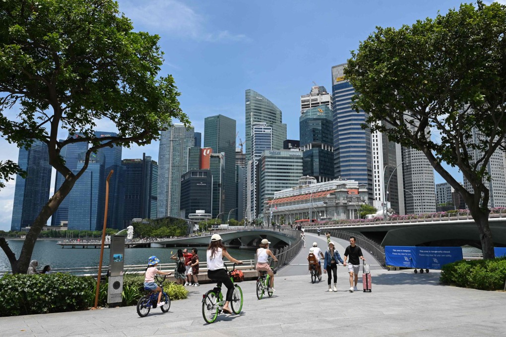 People cross the Jubilee Bridge at Marina Bay in Singapore. The penalties for attempted rape of a minor in the city state are a prison term of between eight and 20 years and at least 12 strokes of the cane. Photo: AFP