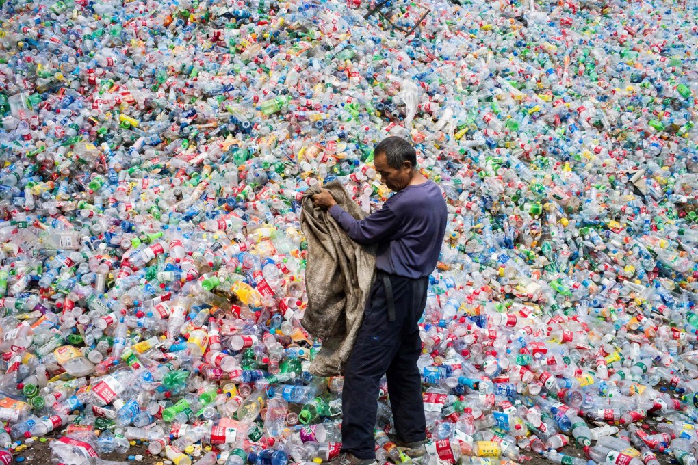 A Chinese labourer sorts plastic bottles for recycling on the outskirts of Beijing. File photo: AFP
