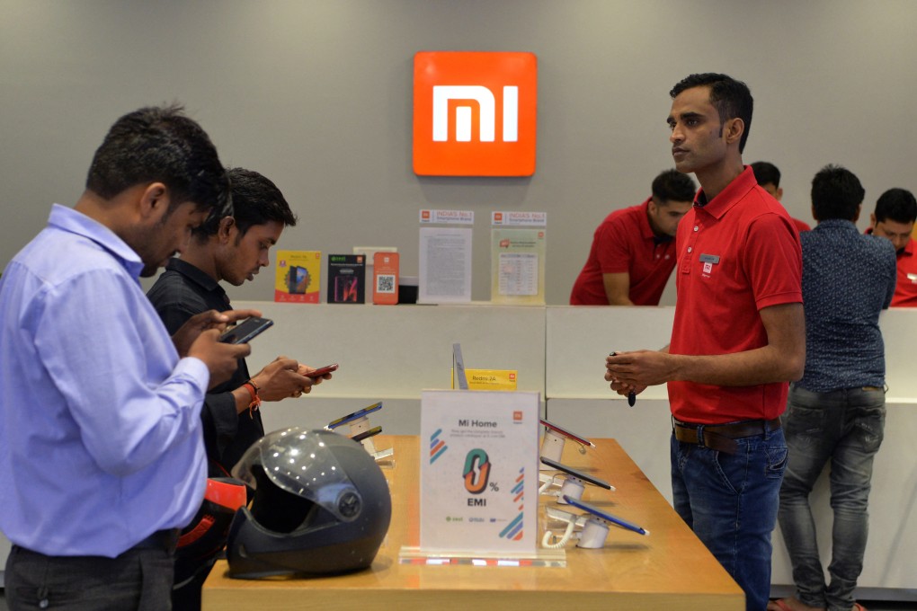 Customers try Xiaomi devices at a Mi store on the outskirts of New Delhi. Photo: AFP